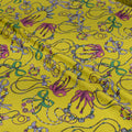 Colorful jewelry patterns on a yellow fabric background