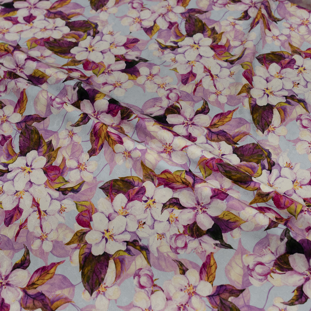 Floral pattern with purple and white flowers on a blue background
