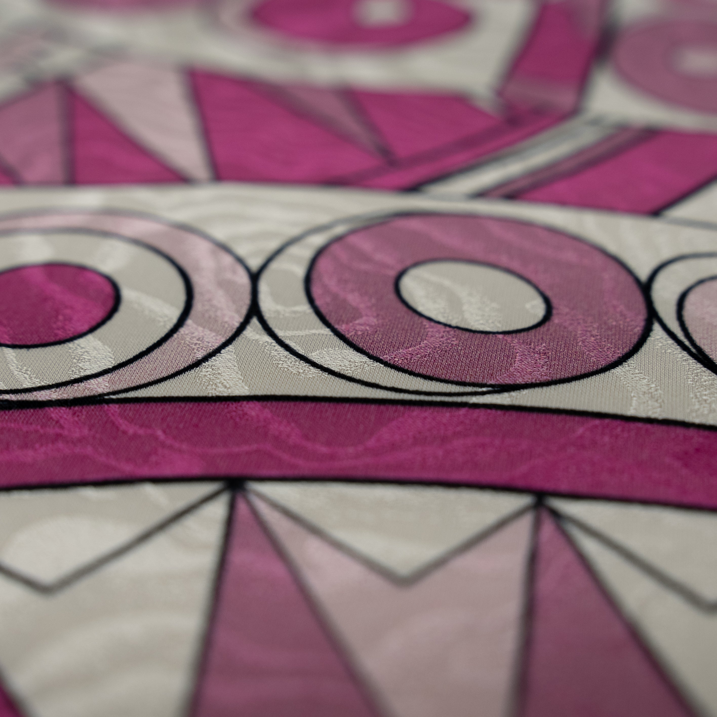 Close-up of a pink and gray geometric patterned fabric