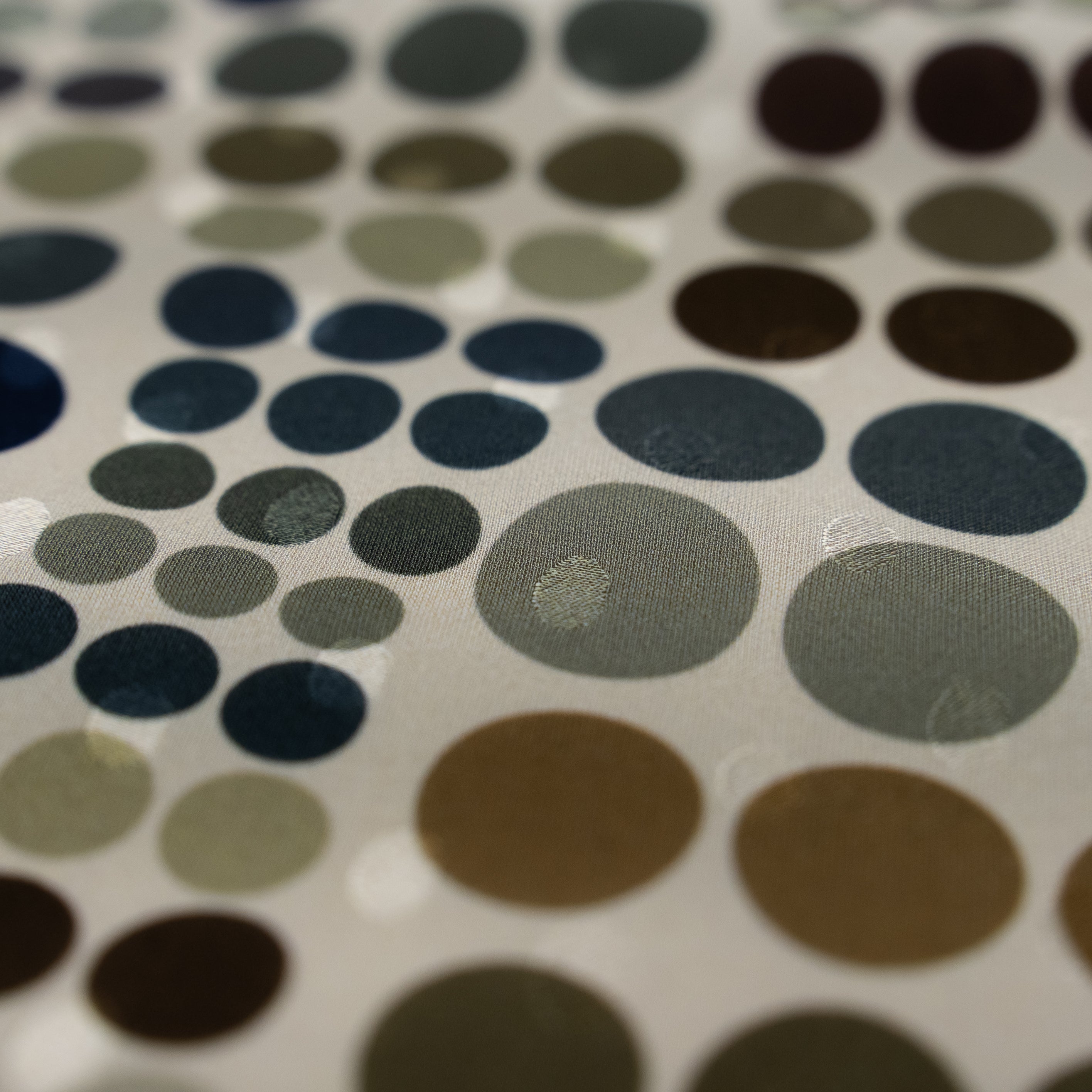 Close-up of a patterned fabric with circular shapes in various colors.