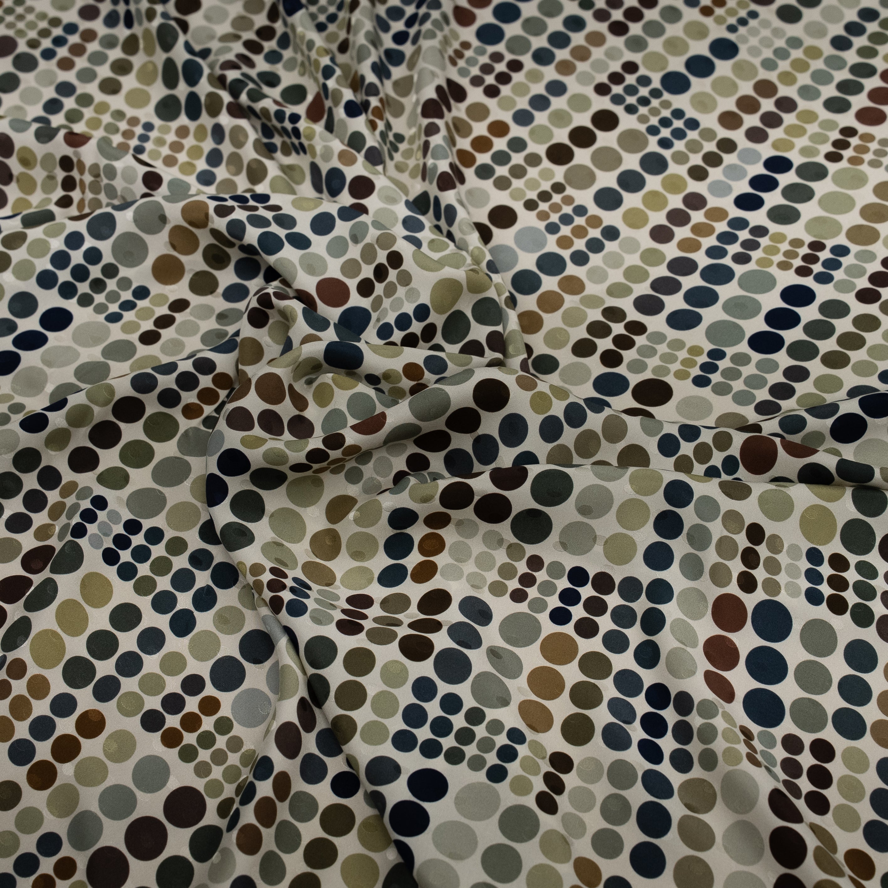 Patterned fabric with multicolored dots on a neutral background