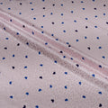 Fabric with blue and black heart patterns on a light background