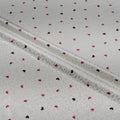 White fabric with red heart patterns and lace trim