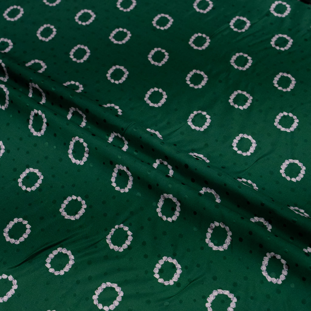 Green fabric with white circular pattern