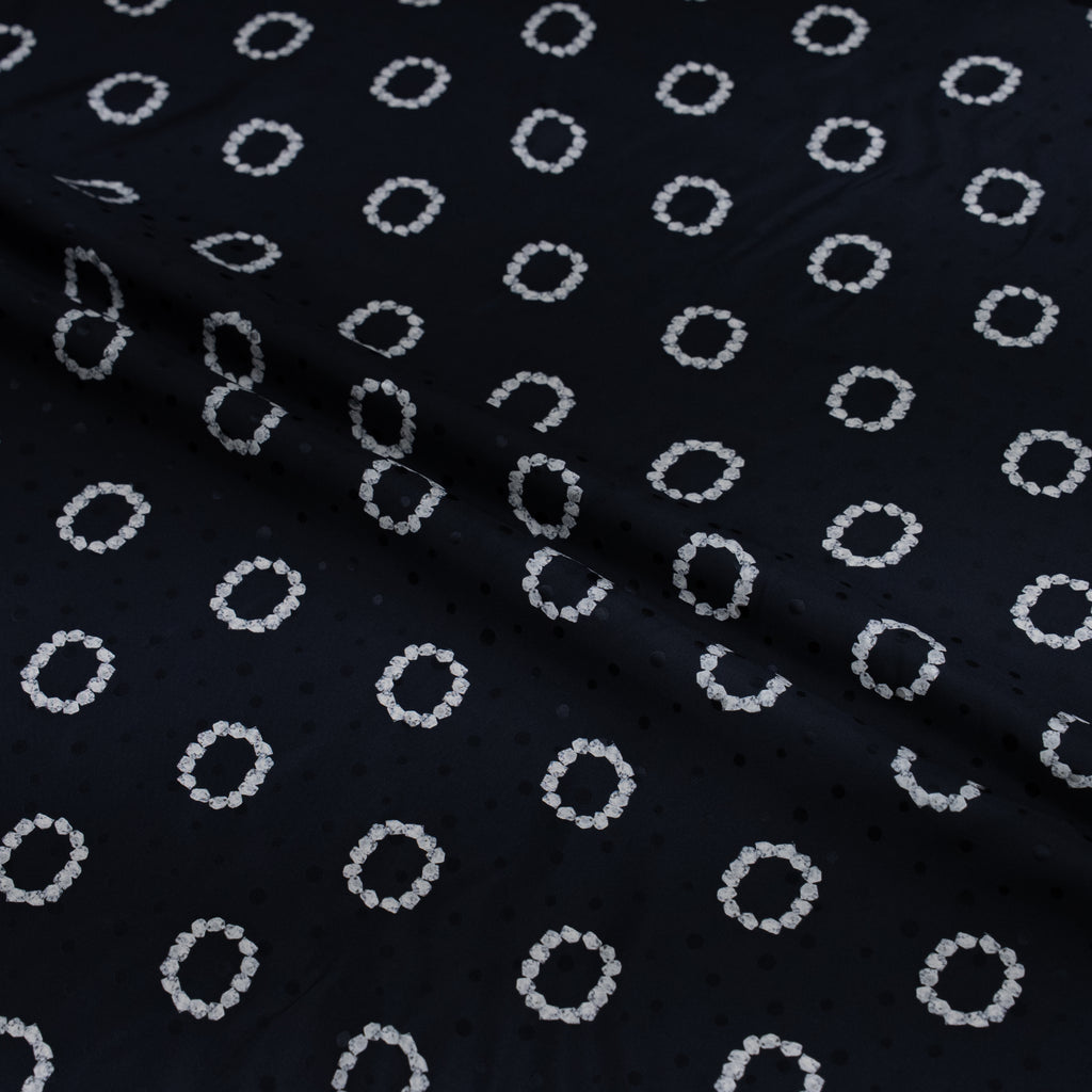 Black fabric with white circular pattern
