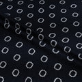 Black fabric with white circular pattern