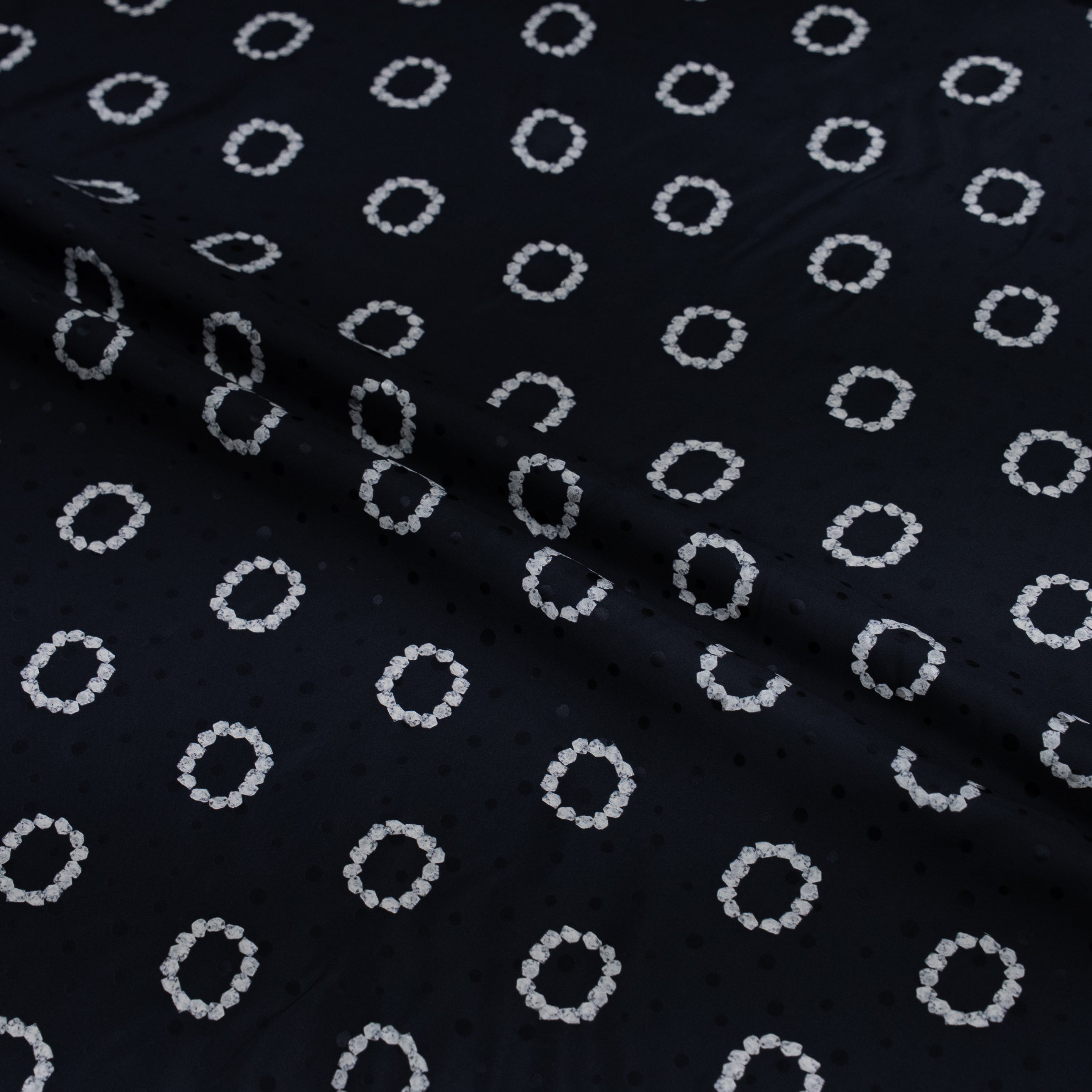 Black fabric with white circular pattern