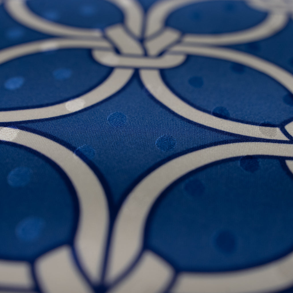 Close-up of blue fabric with white floral pattern