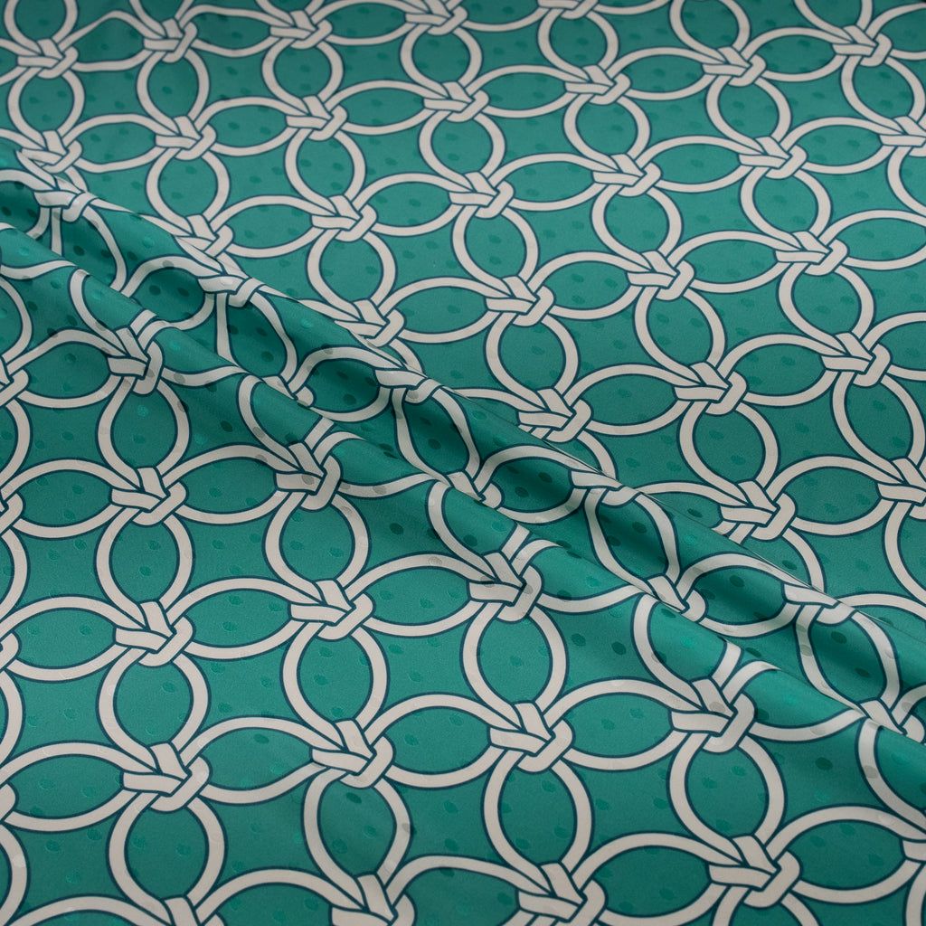 Teal fabric with white geometric pattern