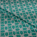 Teal fabric with white geometric pattern
