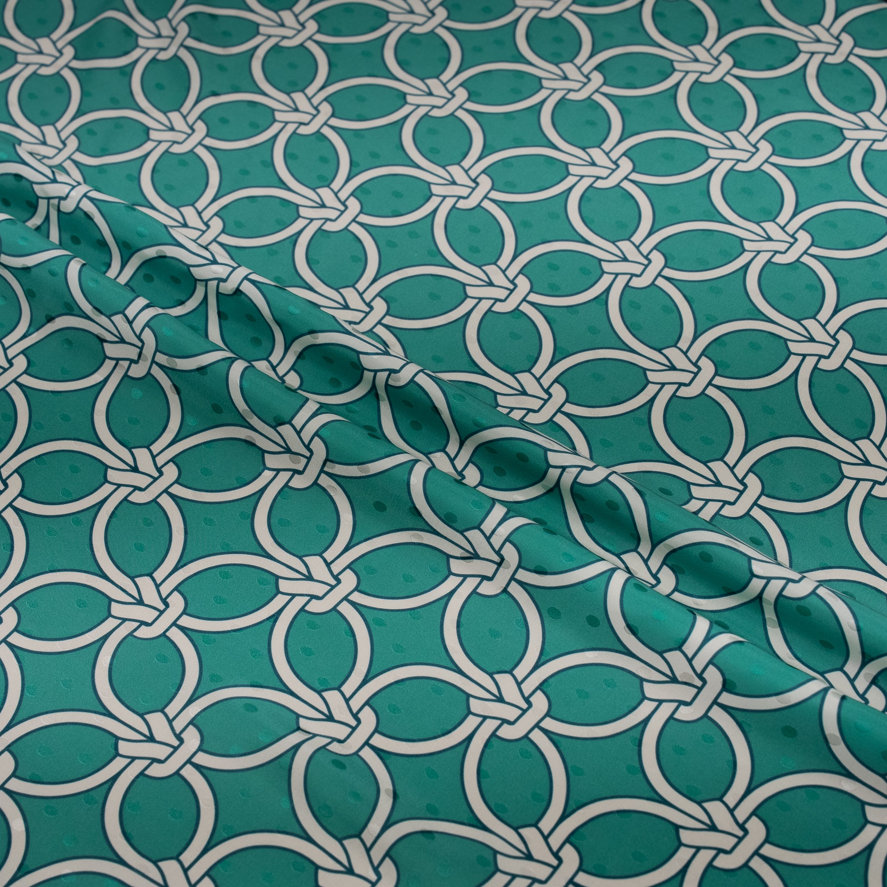 Teal fabric with white geometric pattern