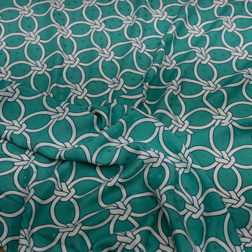 Teal fabric with white geometric pattern