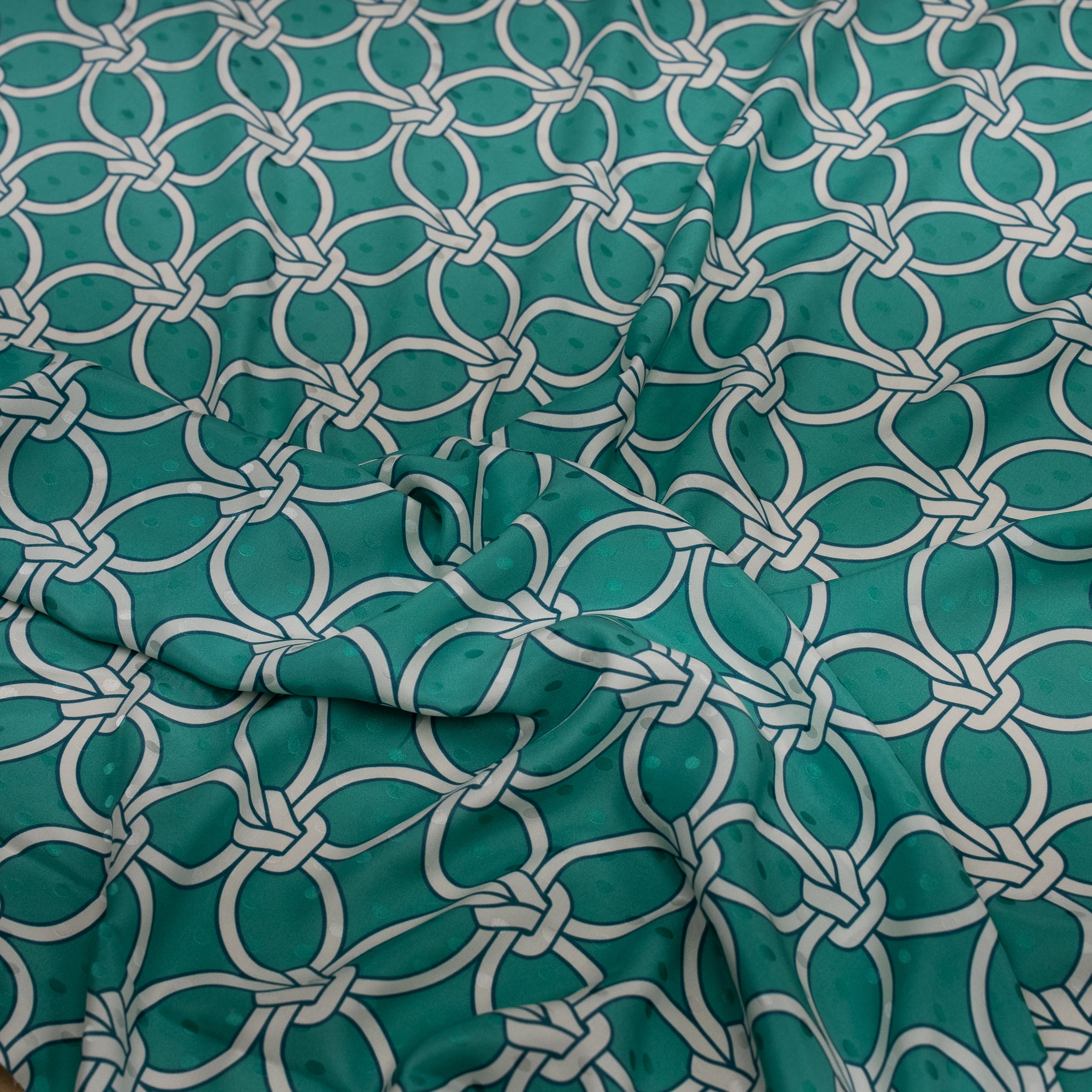Teal fabric with white geometric pattern