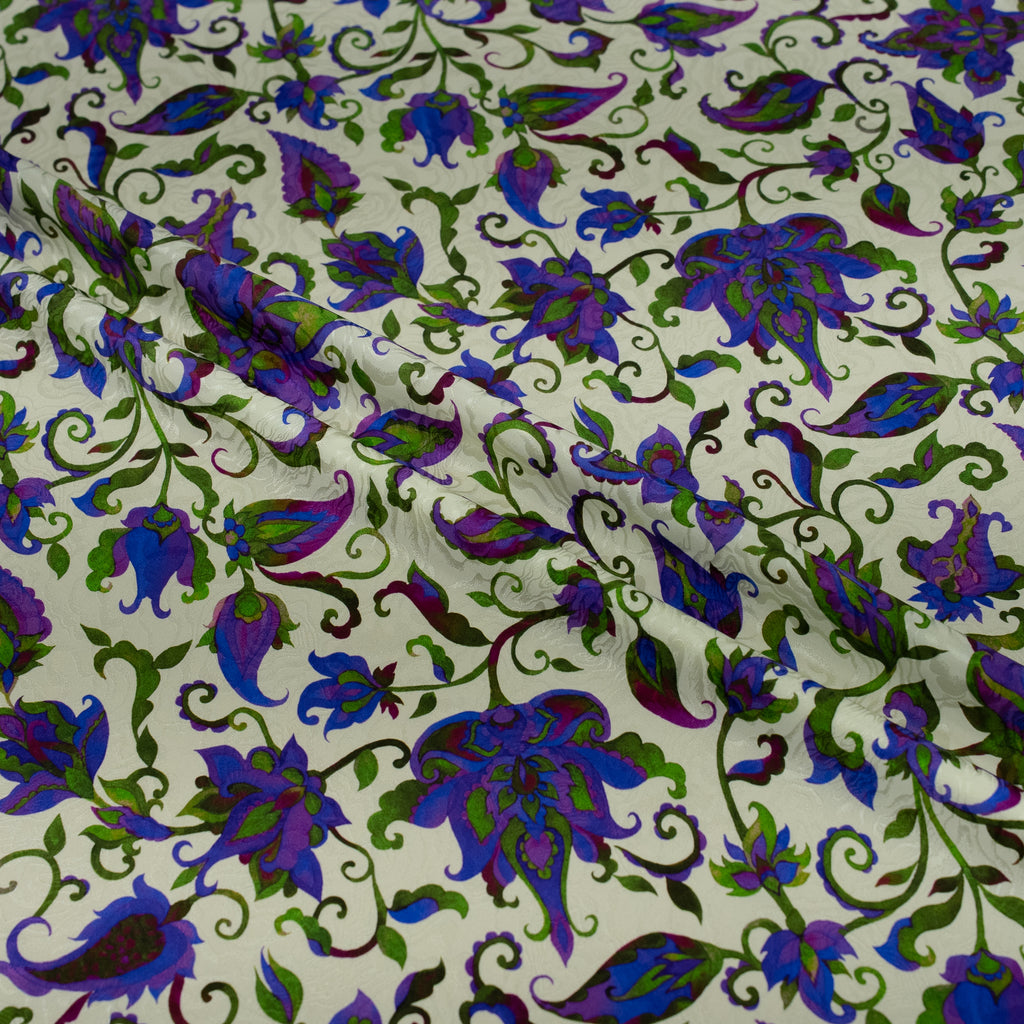Floral patterned fabric with purple and green flowers on a white background