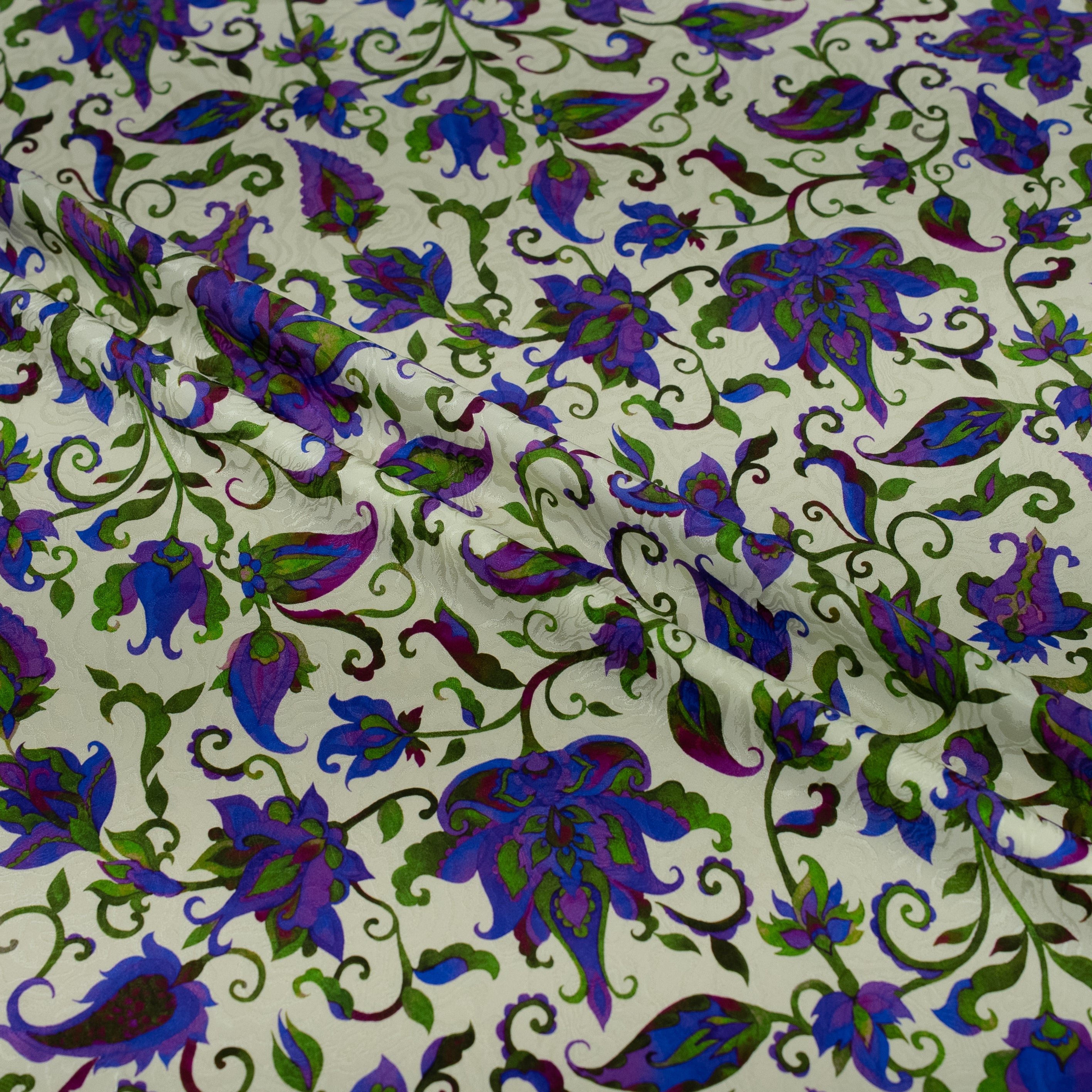 Floral patterned fabric with purple and green flowers on a white background