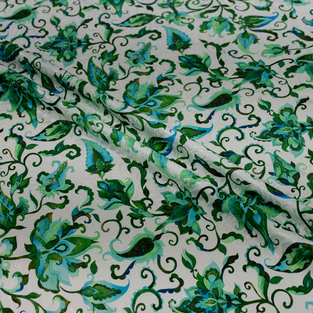 Green floral patterned fabric on a white background
