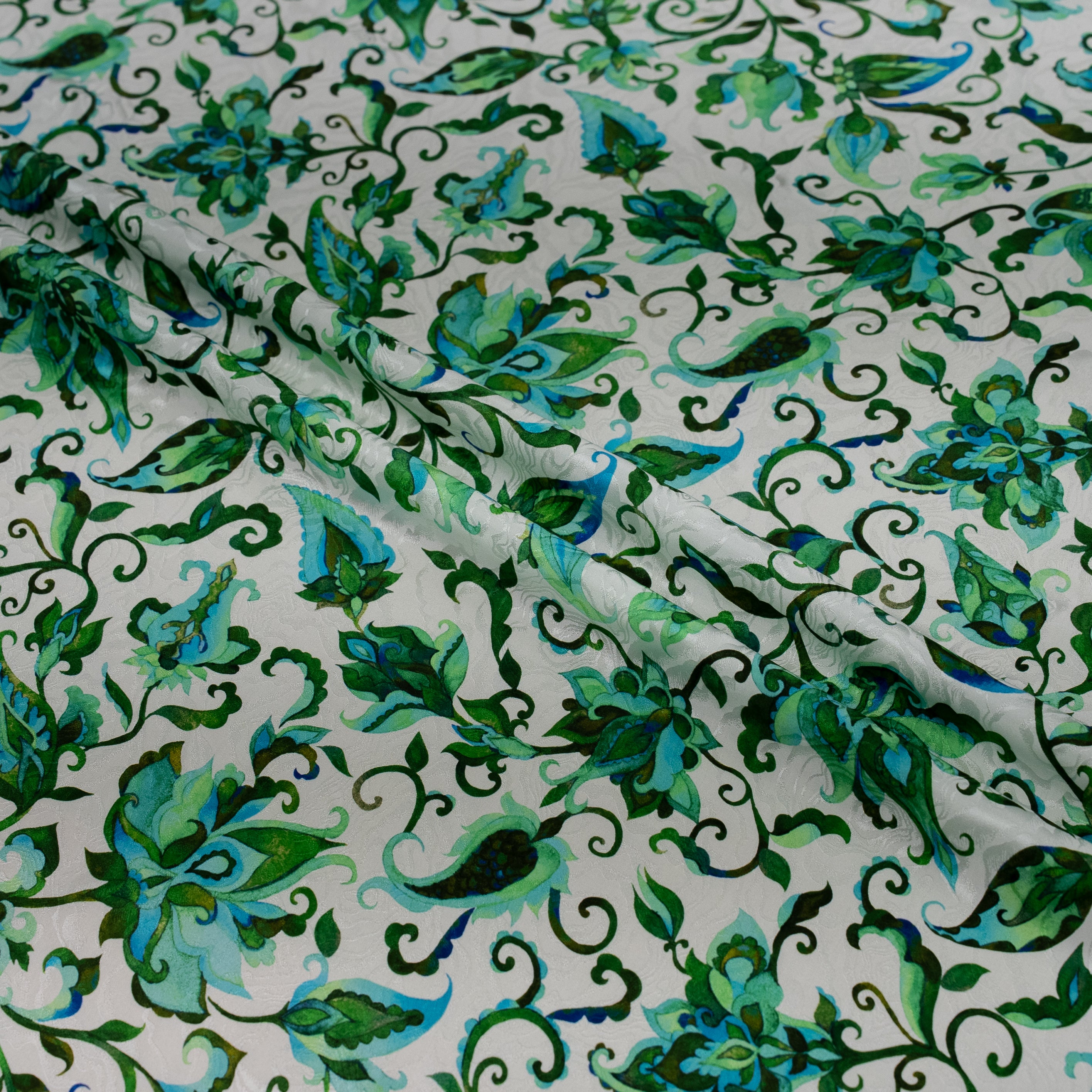Green floral patterned fabric on a white background
