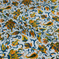 Floral patterned fabric with orange, blue, and green colors on a white background