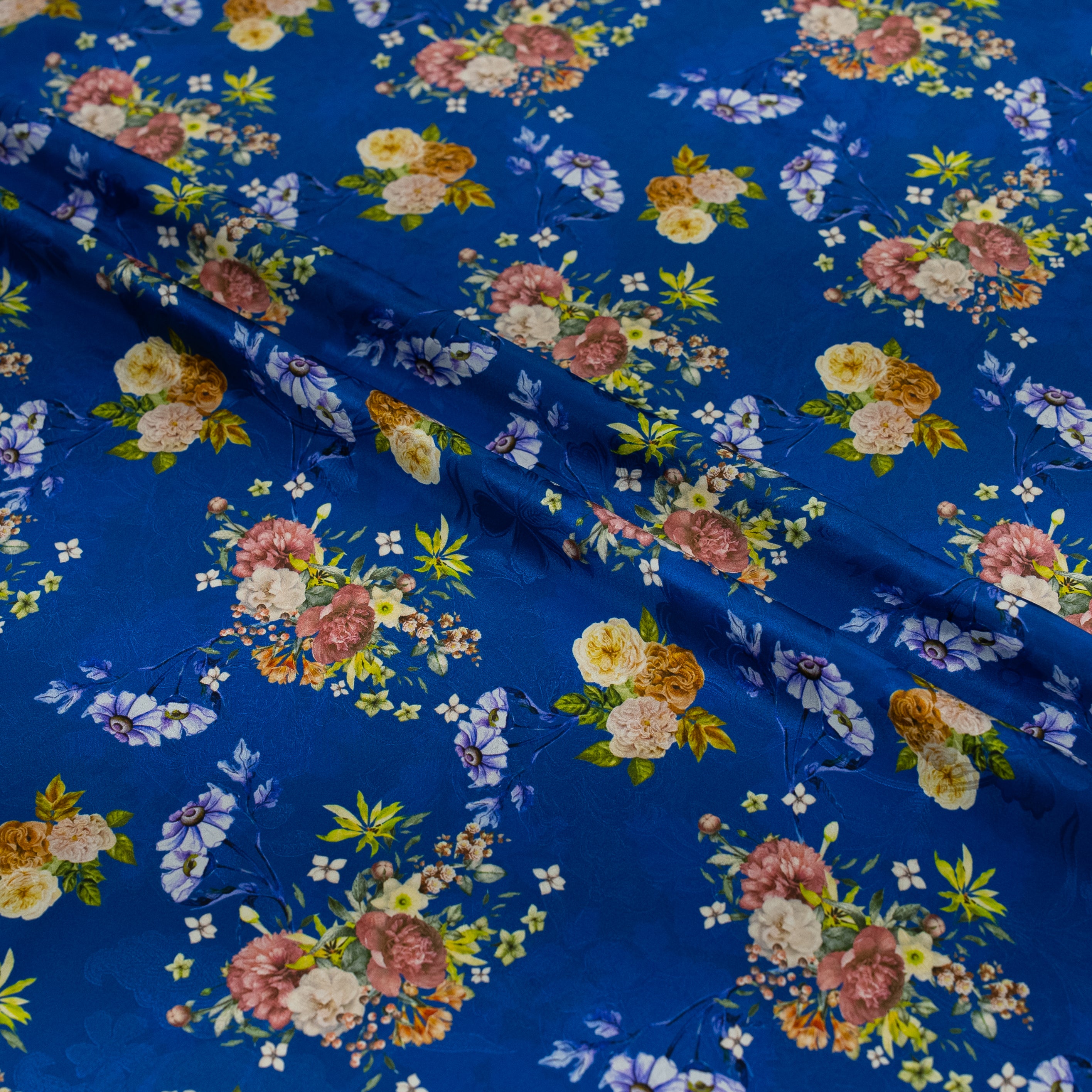 Floral patterned fabric with colorful flowers on a blue background