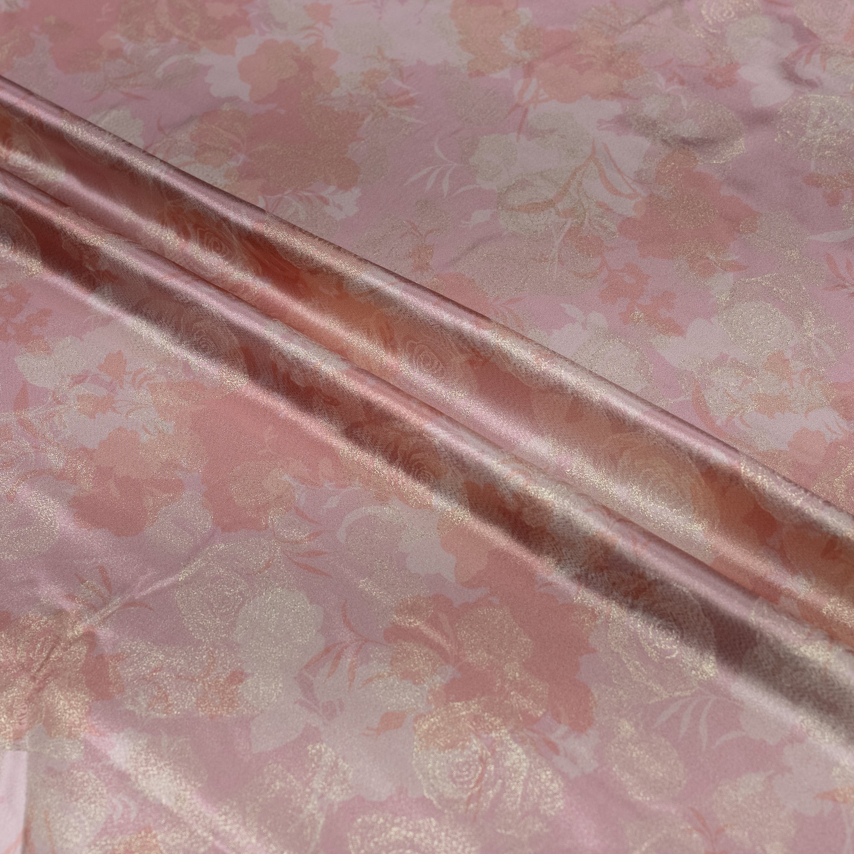 Close-up of pink floral fabric with a shiny texture